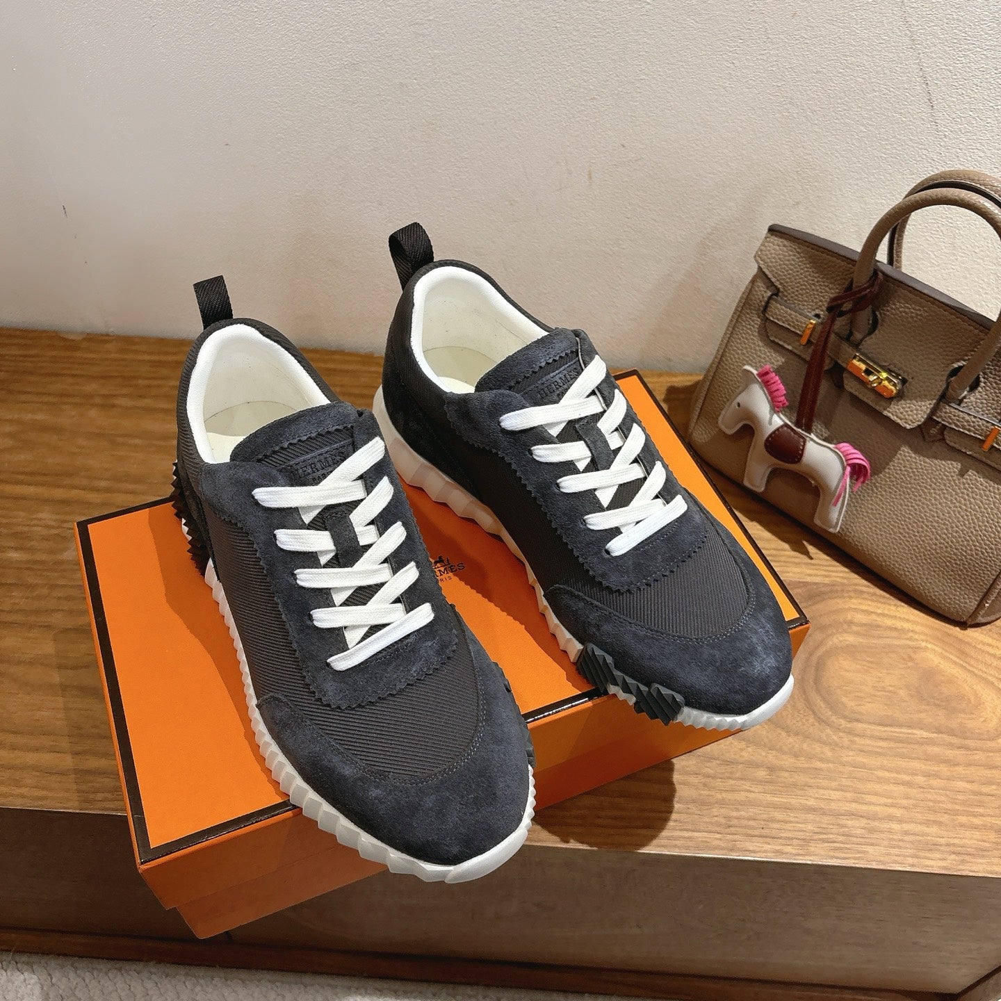 Unisex sneakers pair, dark fabric uppers with white laces and molded white midsoles