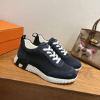 Unisex Hermes navy sneakers with white laces, side patch, and chunky white rubber sole