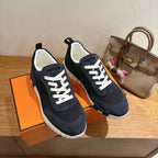 Unisex Hermes sneakers, dark navy suede with white laces and cushioned white midsole