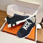 Unisex Hermes low-top sneakers, dark navy suede with white laces and textured sole