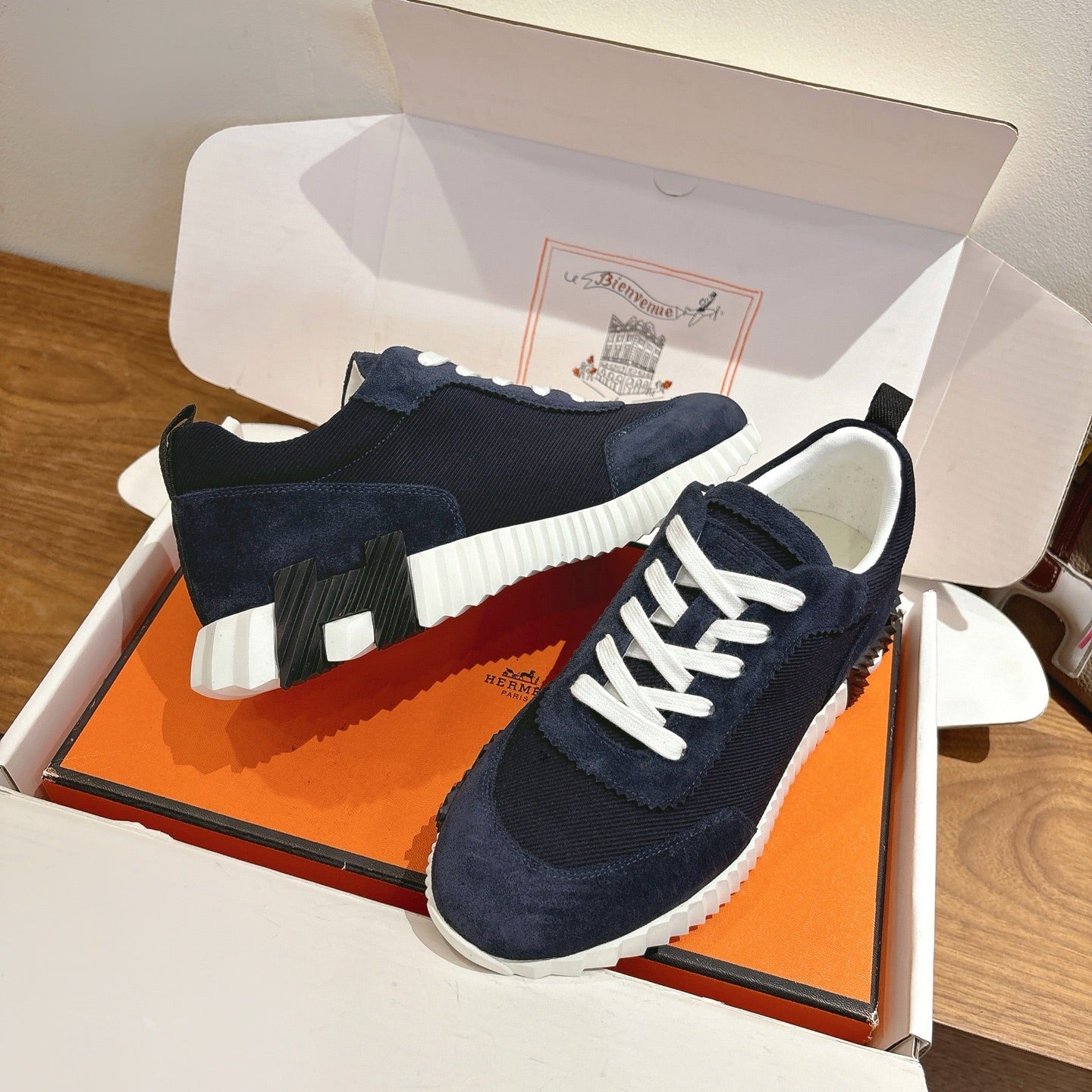 Unisex Hermes low-top sneakers, dark navy suede with white laces and textured sole