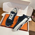 Unisex Hermes suede sneakers on box, dark navy upper, white laces, chunky white sole