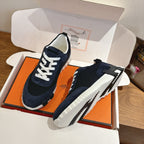 Unisex Hermes suede sneakers on box, dark navy upper, white laces, chunky white sole