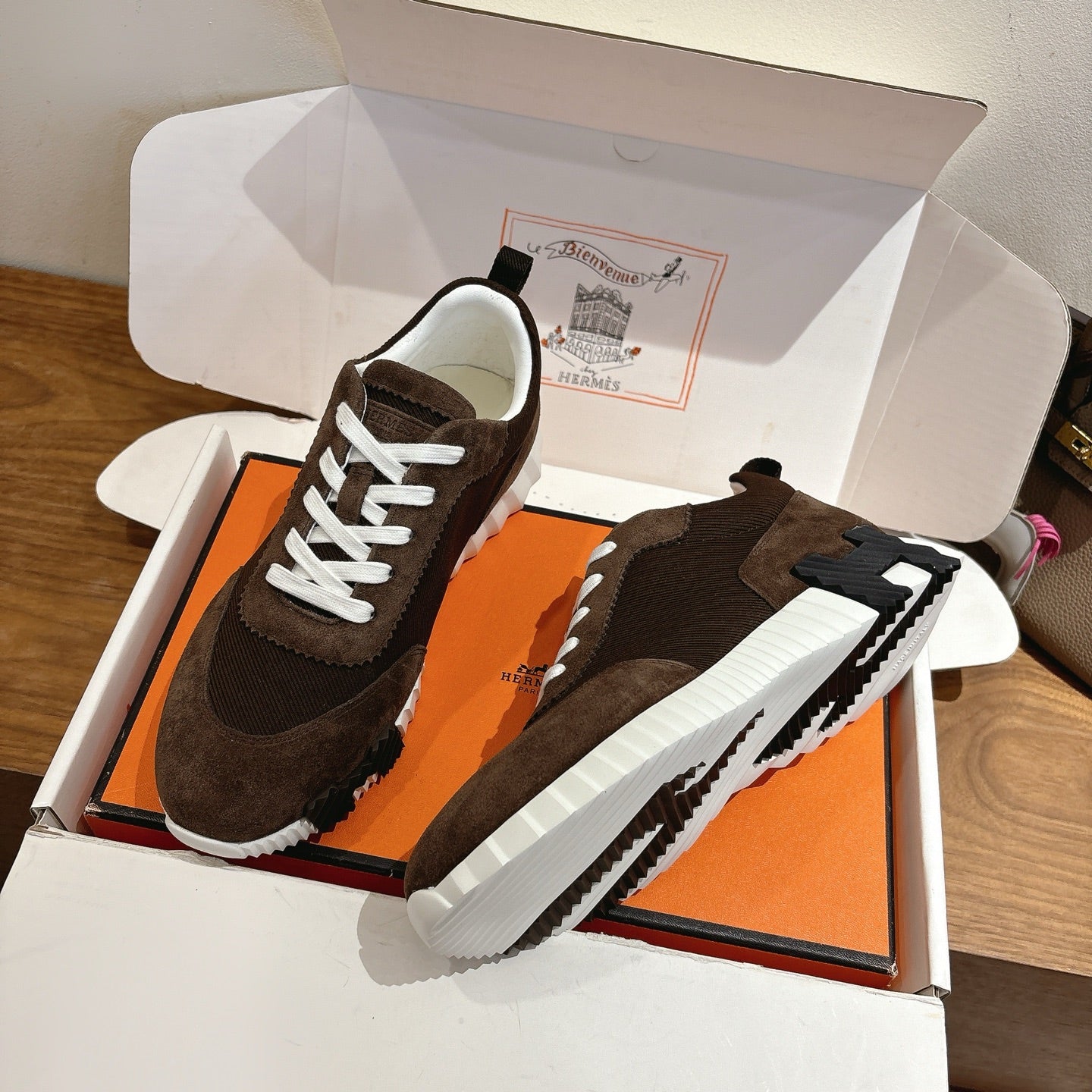 Hermes unisex sneakers, dark brown suede, side view with white laces and white rubber sole