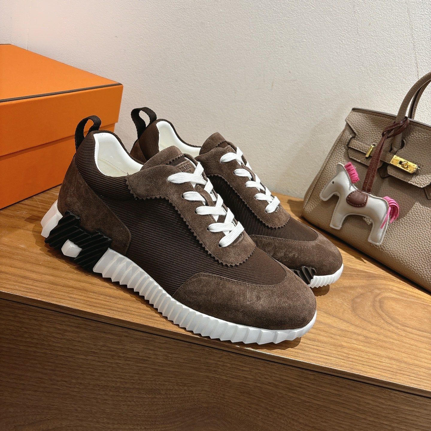 Hermes unisex sneakers, dark brown suede, three-quarter view with white laces