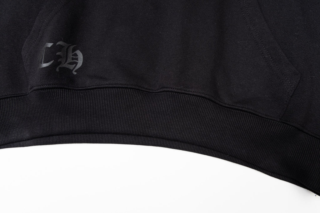 Black long-sleeve hoodie ribbed hem with small stitched logo patch