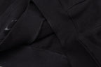 Black hoodie fabric detail with stitched seams and folded panel