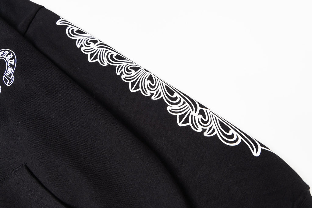 Black long-sleeve hoodie sleeve with white ornamental graphic