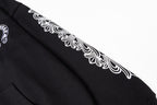 Black long-sleeve hoodie sleeve with white ornamental graphic