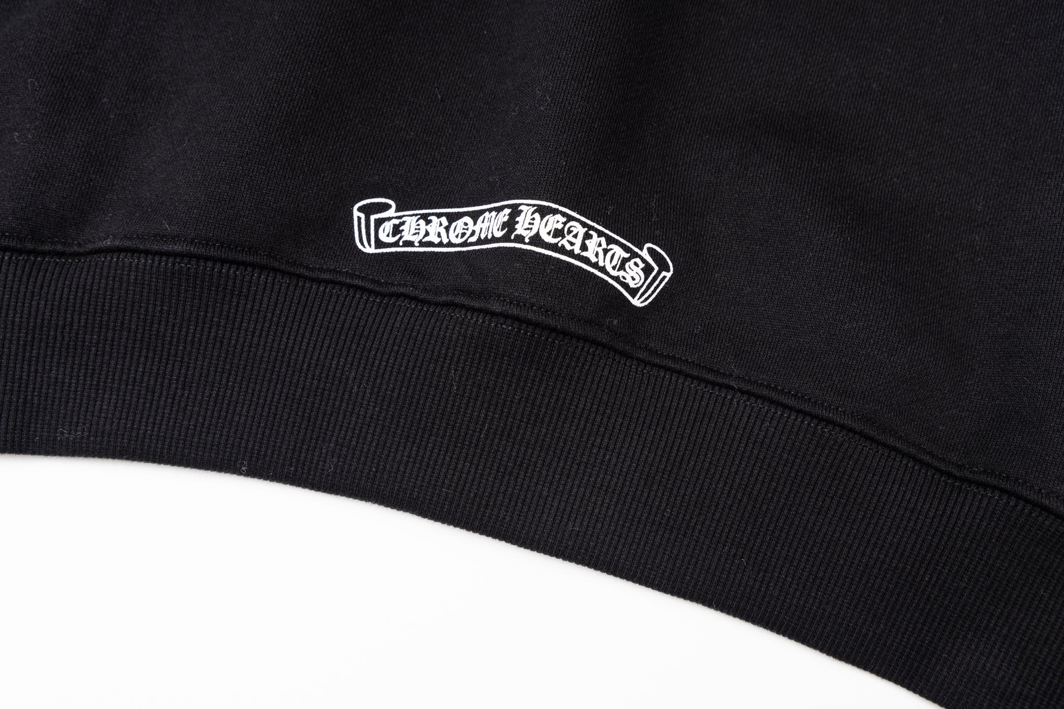 Black long-sleeve hoodie with embroidered chest logo on ribbed hem