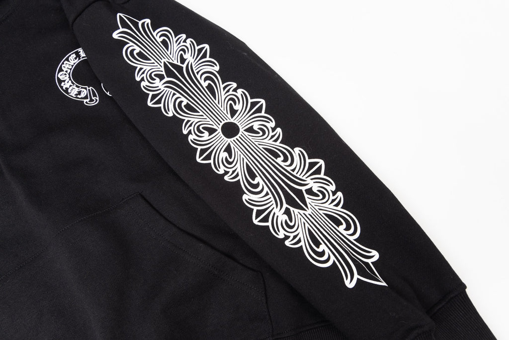 Black hoodie sleeve graphic close-up with ornate floral design