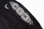 Black hoodie sleeve graphic close-up with ornate floral design