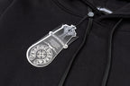 Black hoodie fabric close-up with woven neck label and drawstring top