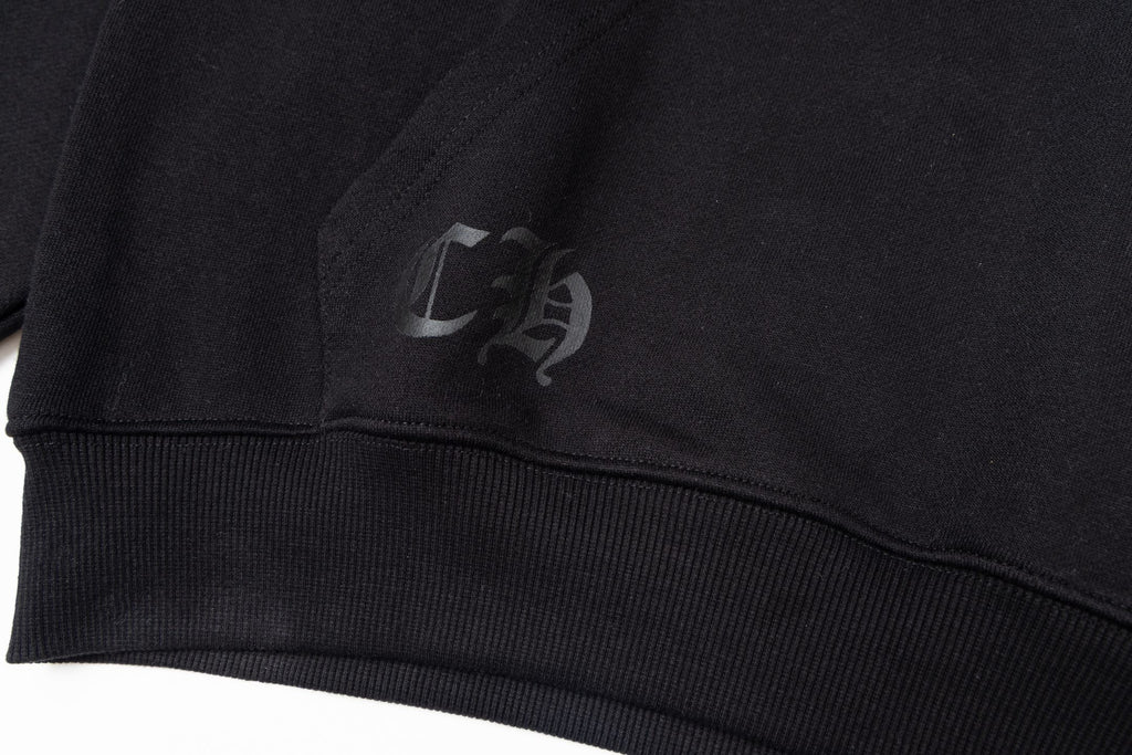 Black long-sleeve hoodie with small chest logo on ribbed cuff