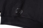 Black long-sleeve hoodie with small chest logo on ribbed cuff