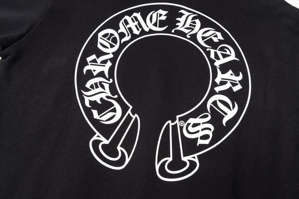 Black hoodie chest graphic close-up with circular text and central emblem