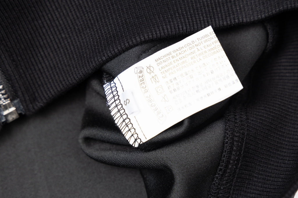 Black jacket neck label inside collar area with care and size info