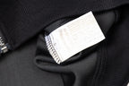 Black jacket neck label inside collar area with care and size info