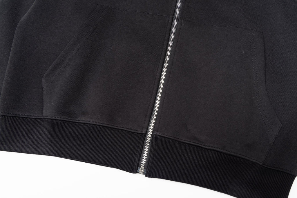 Black zip-up jacket with central zipper and ribbed hem