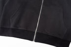 Black zip-up jacket with central zipper and ribbed hem