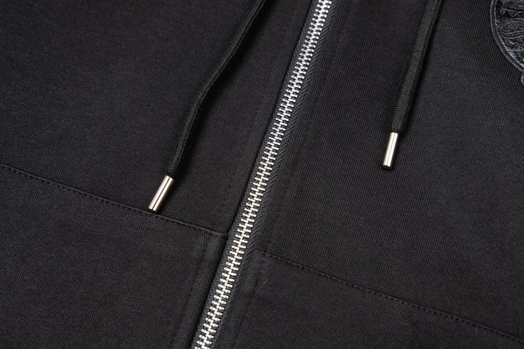 Black hoodie front close-up showing two drawstring tips and zipper seam