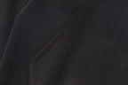 Black jacket fabric with subtle texture and stitched seam line