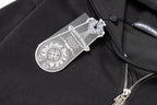 Black hoodie close-up with hanging brand tag near the zipper and pocket