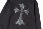 Black zip-up jacket with chrome-style cross emblem and stitched detailing