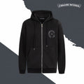 Black zip-up hoodie with hood, drawstrings, front pockets, and chest emblem patch