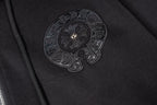 Black hoodie side close-up with embroidered round emblem patch