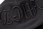 Black hoodie sleeve close-up with embroidered script logo text