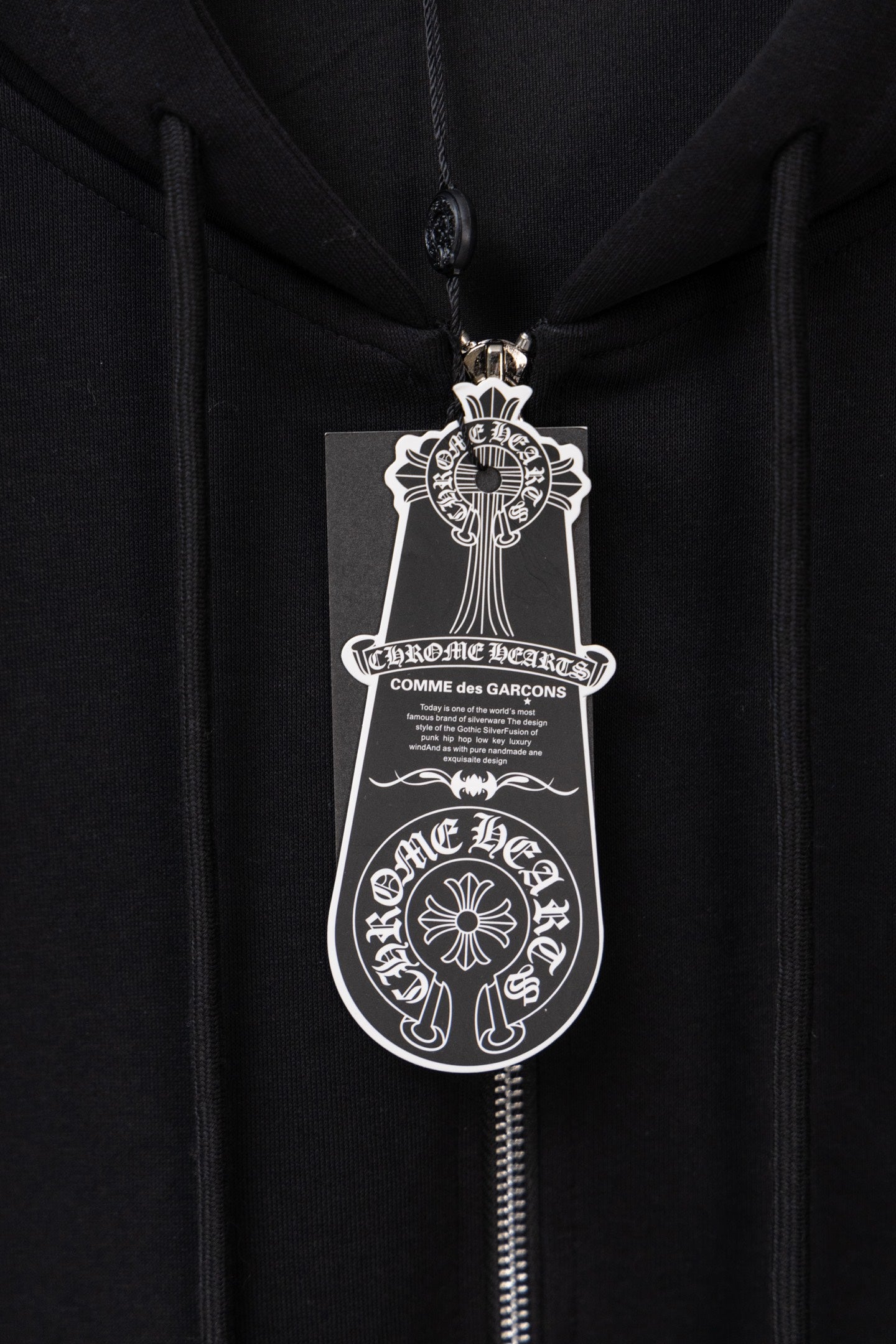Black zip hoodie with front zipper and large logo crest graphic