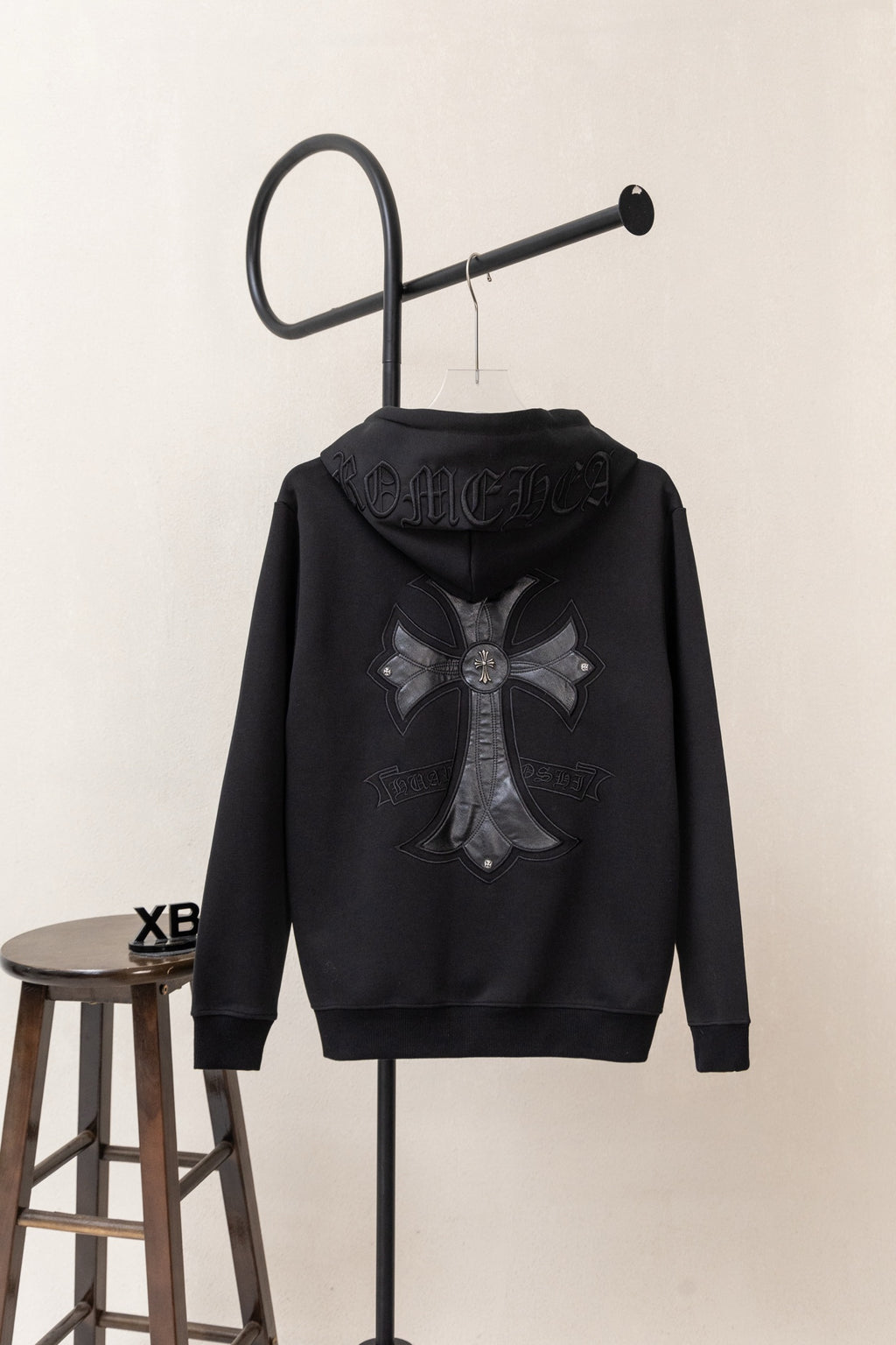 Black zip-up hoodie turned backward with large back graphic and hood