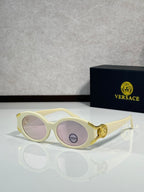 Sunglasses with cream round frames, gold accents, purple-tinted lenses