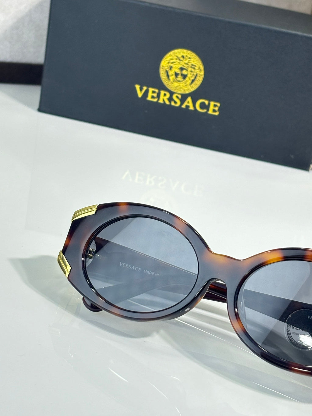 Sunglasses close-up with tortoise round frames and light tinted lenses