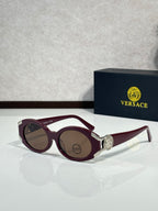 Sunglasses with burgundy round frames, silver side details, brown lenses