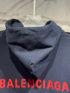 Dark denim hooded jacket with red Balenciaga logo across hem