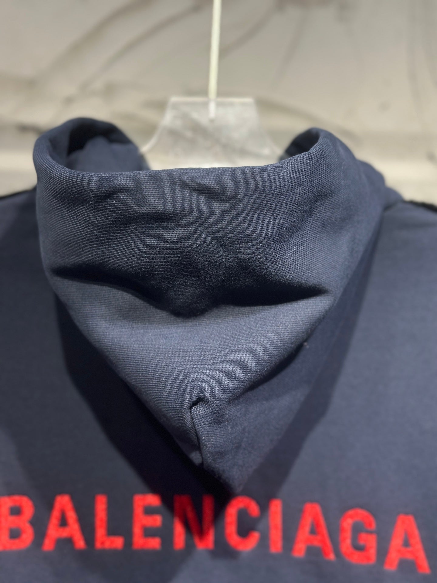 Dark denim hooded jacket with red Balenciaga logo across hem
