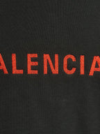 Dark hooded jacket with red Balenciaga lettering