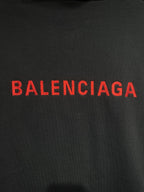 Dark fabric hooded jacket with red Balenciaga logo
