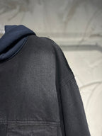 Dark denim hooded jacket sleeve and shoulder seam detail