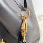 YSL black leather bag with gold keyring clasp and adjustable strap hardware
