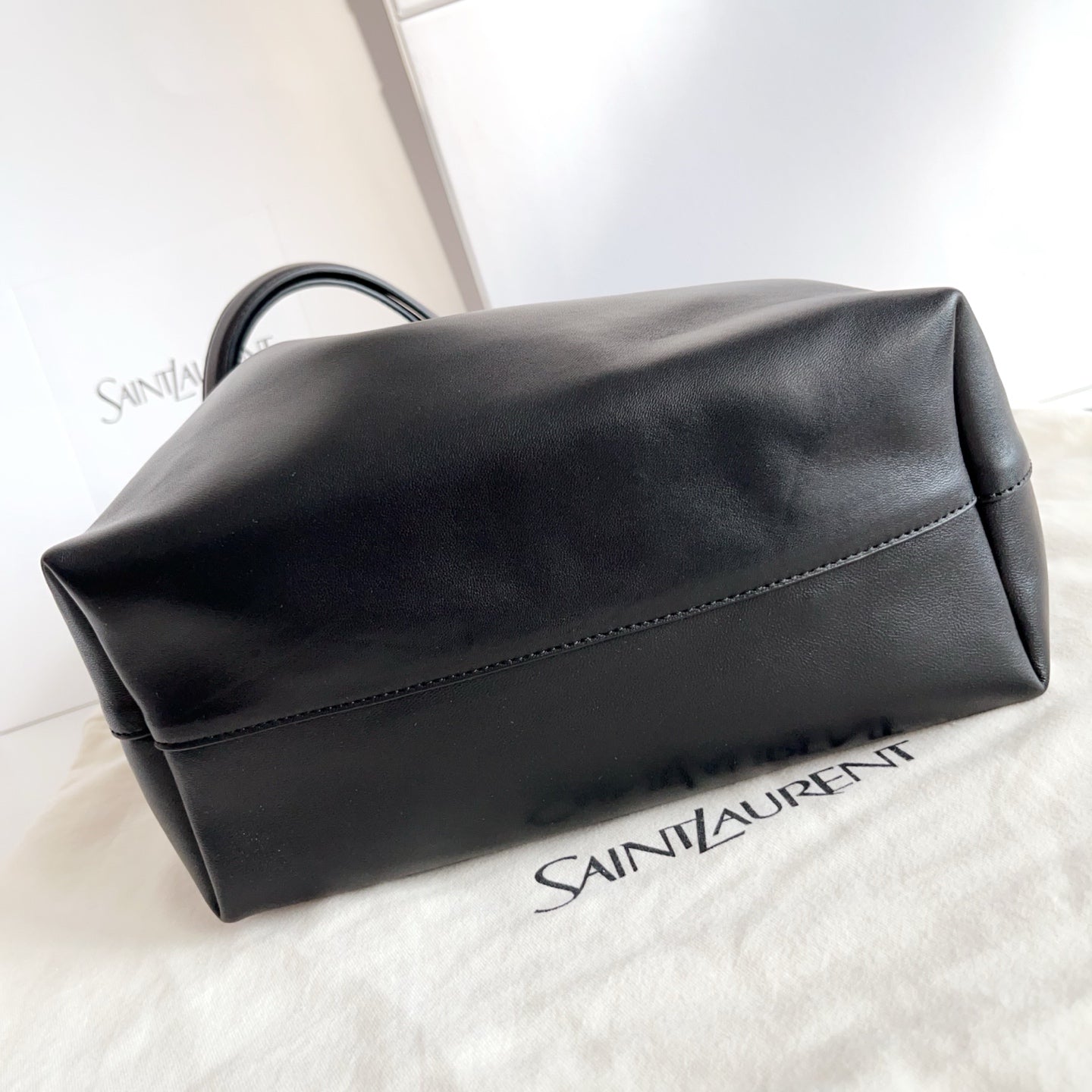 YSL black leather clutch bag with curved flap and stitched top edge