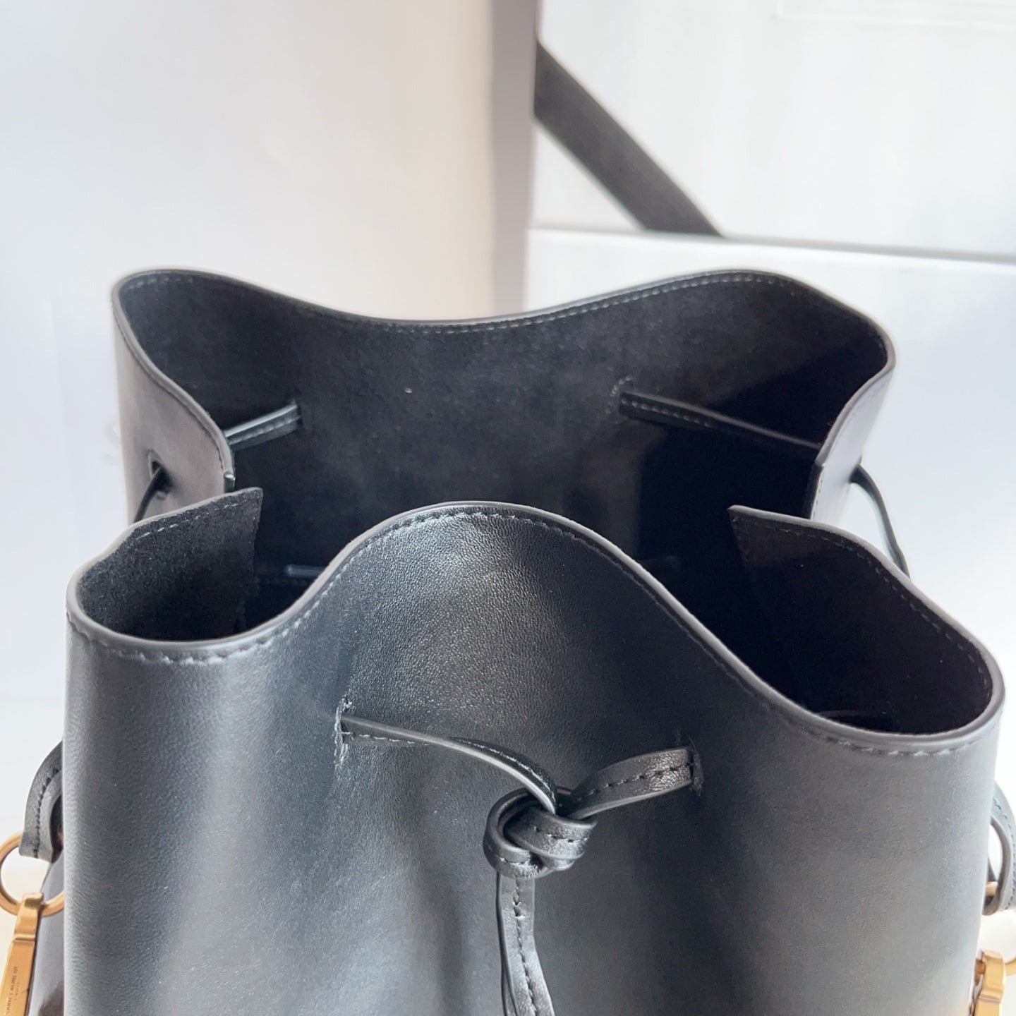 YSL black leather bag interior with open top, side pockets, and lining