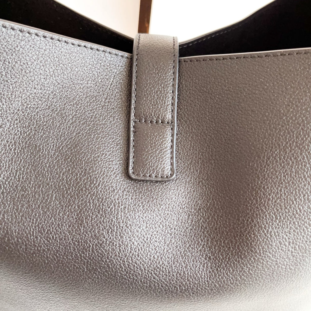 YSL black leather bag top opening with stitched vertical tab detail