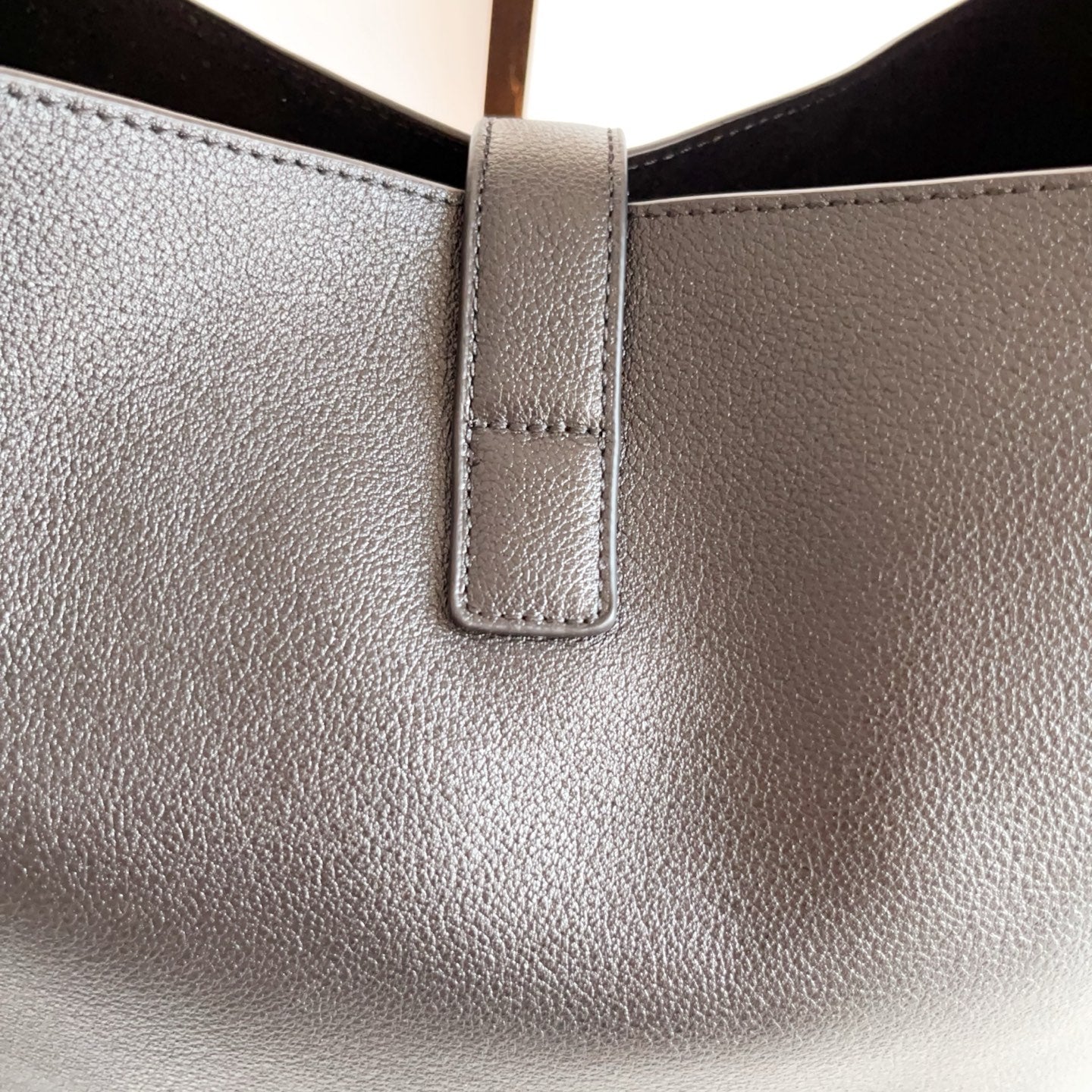 YSL black leather bag top opening with stitched vertical tab detail