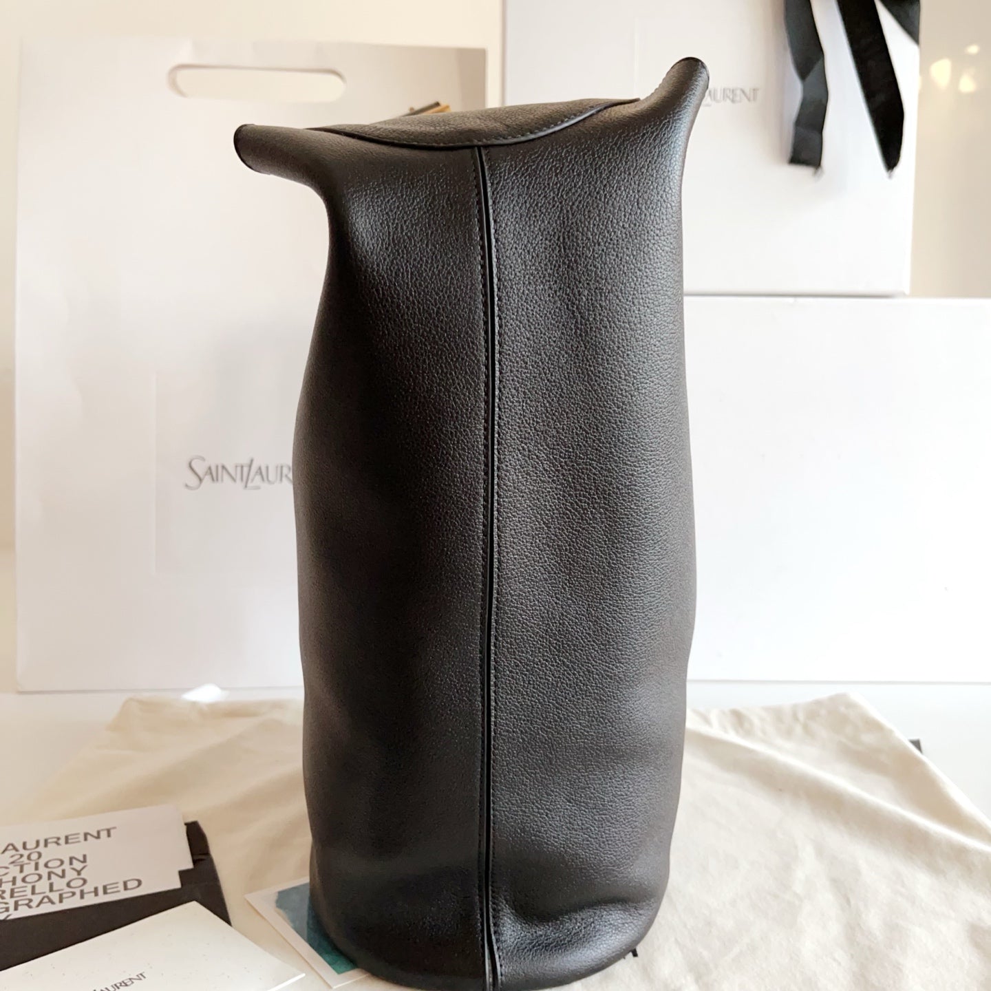 YSL black leather hobo tote bag, side view with vertical center seam