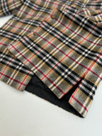 Burberry plaid shirt hem with black underside lining, close-up