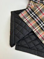 Burberry plaid shirt with black quilted lining panel, edge close-up