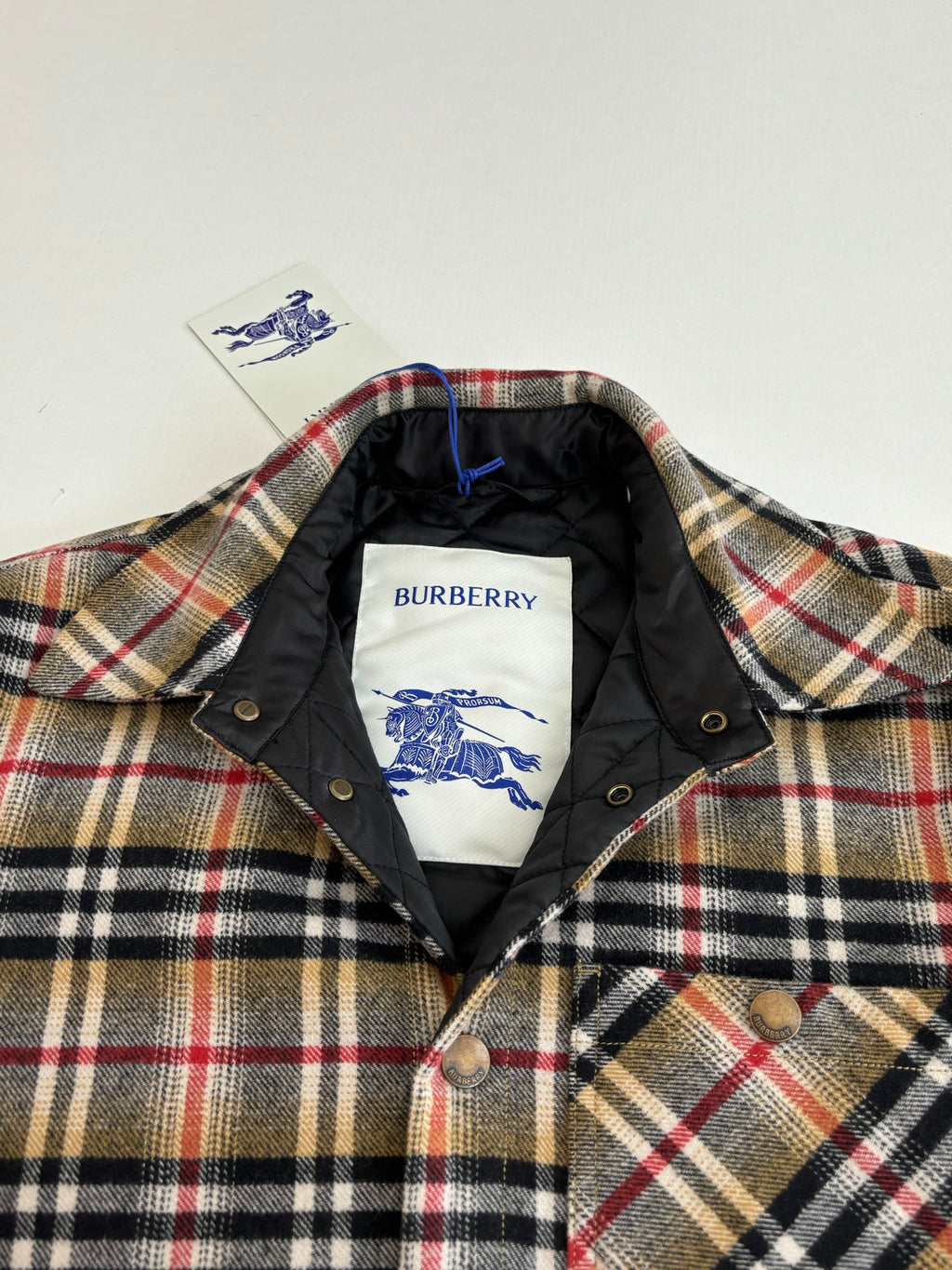 Burberry plaid jacket collar with black lining and embroidered logo on inner tag